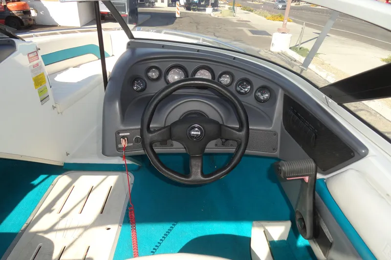 Slide: The Image of 1995 Wellcraft Eclipse 196 S boat dashboard with steering wheel and gauges. - 8