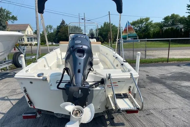 Slide: The Image of 2015 Triumph 170 CC boat with outboard motor, parked on concrete surface. - 7