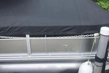 Slide: The Image of 2019 Bennington 22 SCWXP pontoon boat with black cover at dock. - 10