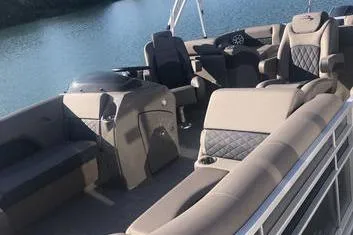 Slide: The Image of 2019 Bennington 22 SCWXP pontoon boat with luxurious seating on a calm lake. - 11