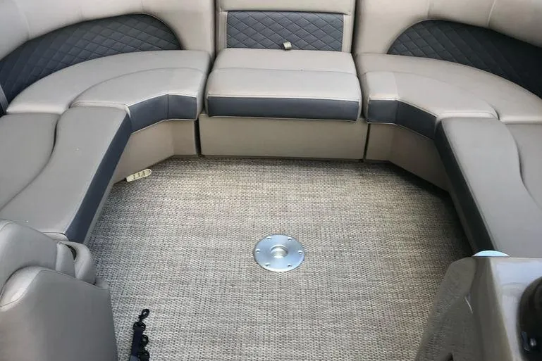 Slide: The Image of 2019 Bennington 22 SCWXP boat interior with cushioned seating and carpeted floor. - 2