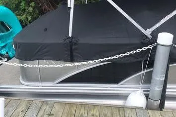 Slide: The Image of 2019 Bennington 22 SCWXP pontoon boat docked with cover and chain. - 24