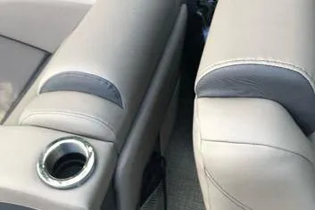 Slide: The Image of 2019 Bennington 22 SCWXP boat interior with beige seating and cup holder. - 32