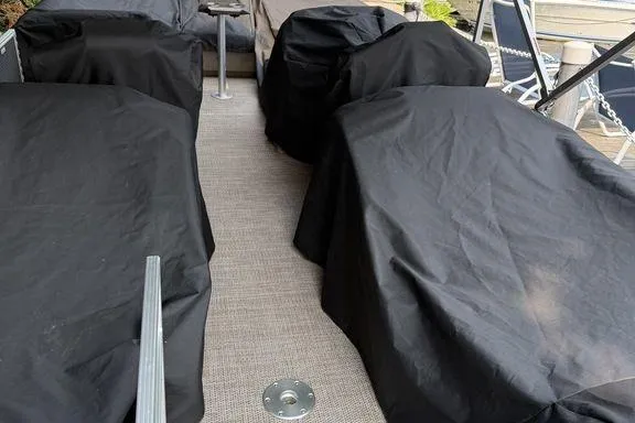 Slide: The Image of 2019 Bennington 22 SCWXP boat interior with covered seating and carpeted floor. - 7