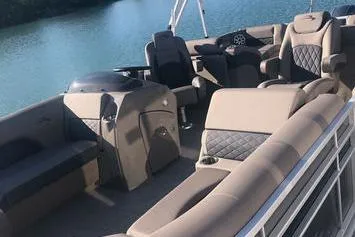 Slide: The Image of 2019 Bennington 22 SCWXP pontoon boat with luxurious seating on a serene lake. - 8
