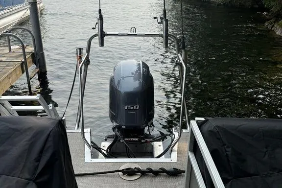 Slide: The Image of 2019 Bennington 22 SCWXP boat with 150 HP outboard motor docked by the water. - 9