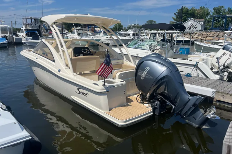 The Image of 2024 Scout 240 Dorado boat docked, featuring Yamaha outboard motor and American flag. - 0