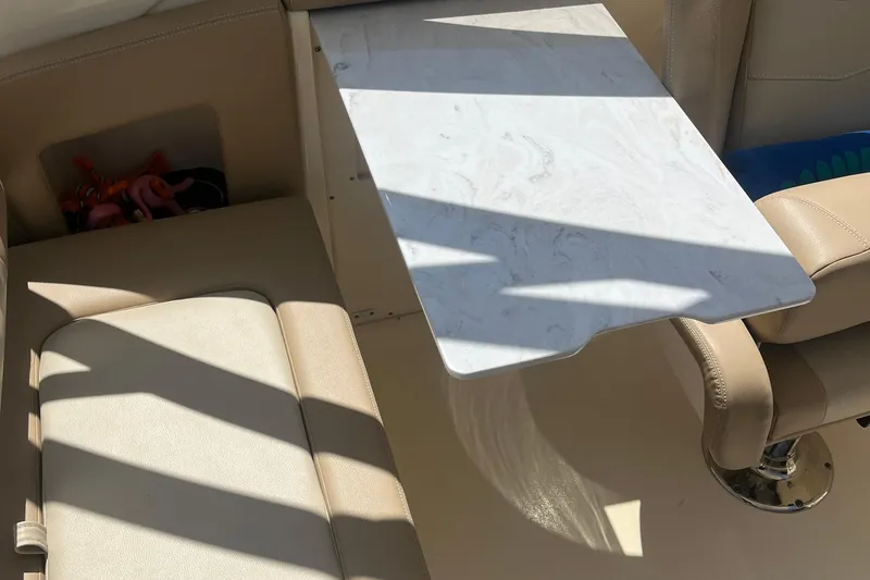 Slide: The Image of 2024 Scout 240 Dorado interior with beige seating and a marble-style table. - 15