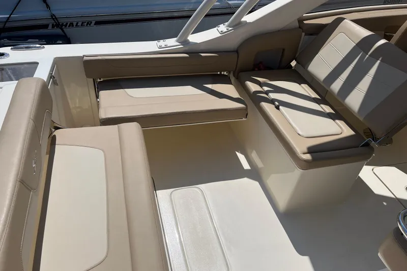 Slide: The Image of 2024 Scout 240 Dorado boat interior with beige seating and sleek design. - 16