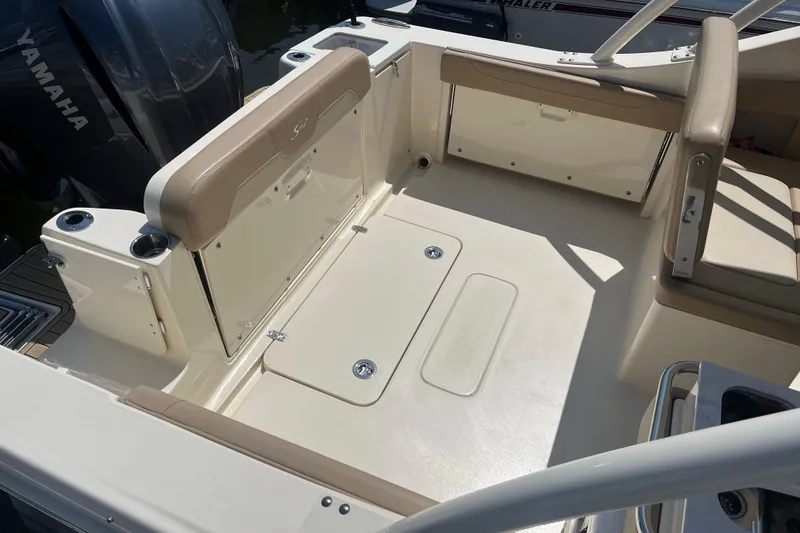 Slide: The Image of 2024 Scout 240 Dorado boat interior with seating and Yamaha engine. - 7