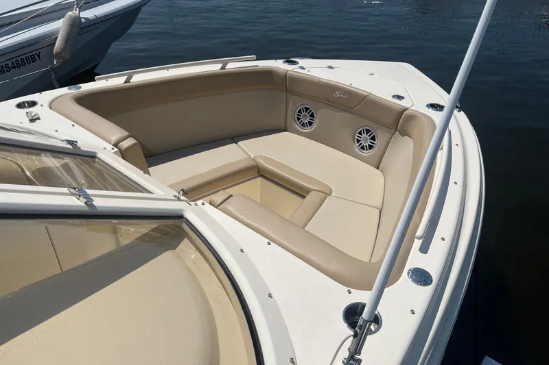 Slide: The Image of 2024 Scout 240 Dorado boat with beige seating and speakers on the deck. - 8