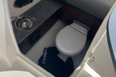 Slide: The Image of 2019 Chaparral 250 Suncoast boat interior with toilet and sink. - 13