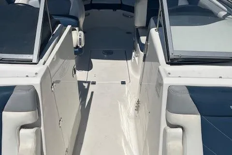 Slide: The Image of 2019 Chaparral 250 Suncoast boat interior with seating and open deck layout. - 15