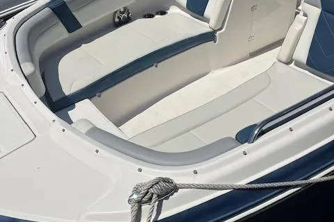 Slide: The Image of 2019 Chaparral 250 Suncoast boat interior with white and blue seating. - 3