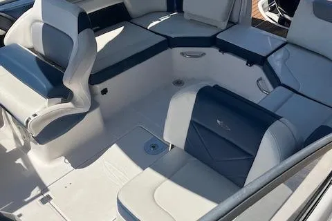 Slide: The Image of 2019 Chaparral 250 Suncoast boat interior with white and navy seating arrangement. - 4