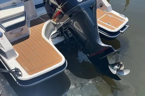 Slide: The Image of 2019 Chaparral 250 Suncoast boat with outboard motor and teak-style swim platform. - 6