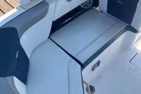 Slide: The Image of 2019 Chaparral 250 Suncoast boat interior seating with blue and white upholstery. - 7