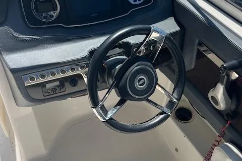 Slide: The Image of Steering wheel and dashboard of 2019 Chaparral 250 Suncoast boat. - 9