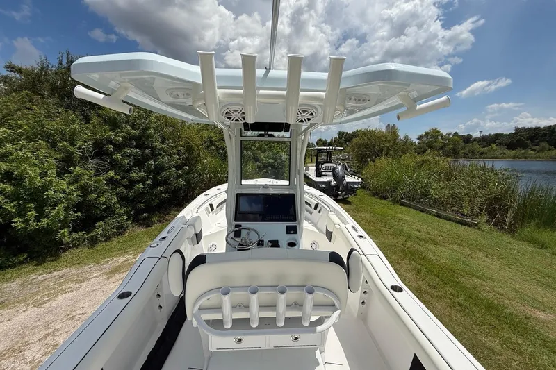 Slide: The Image of 2026 Tidewater 232 LXF boat with modern console, docked near lush greenery and water. - 13