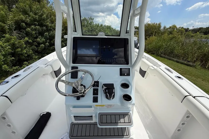 Slide: The Image of 2026 Tidewater 232 LXF boat console with steering wheel and navigation display. - 14