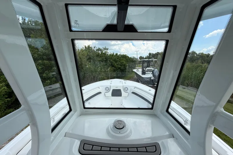 Slide: The Image of Interior view of 2026 Tidewater 232 LXF boat through windshield, showcasing sleek design. - 16