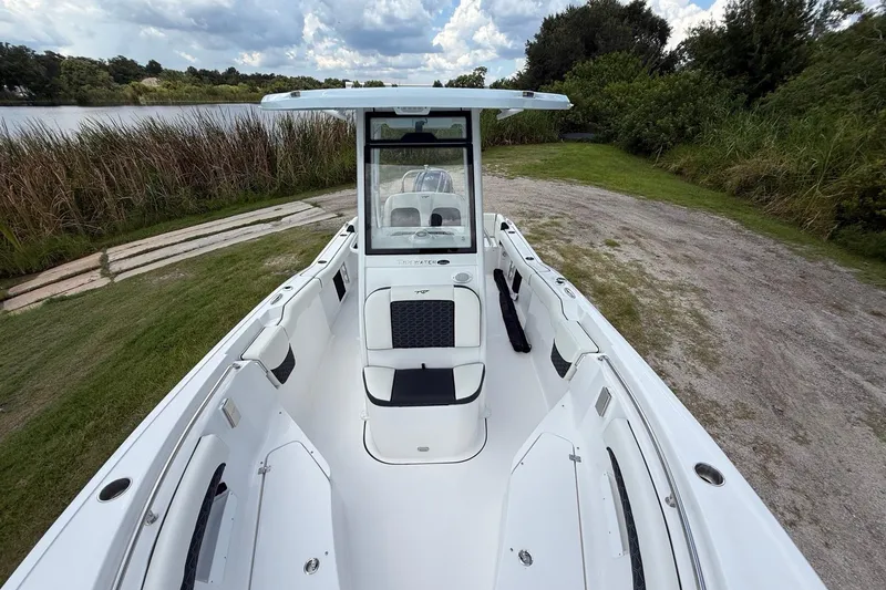 Slide: The Image of 2026 Tidewater 232 LXF boat on grassy shore, showcasing sleek design and spacious interior. - 18