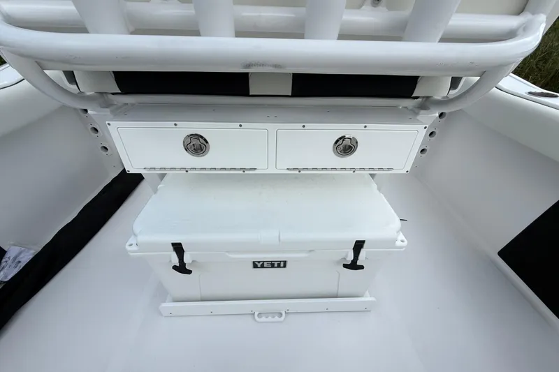 Slide: The Image of 2026 Tidewater 232 LXF boat interior with Yeti cooler and storage compartments. - 28