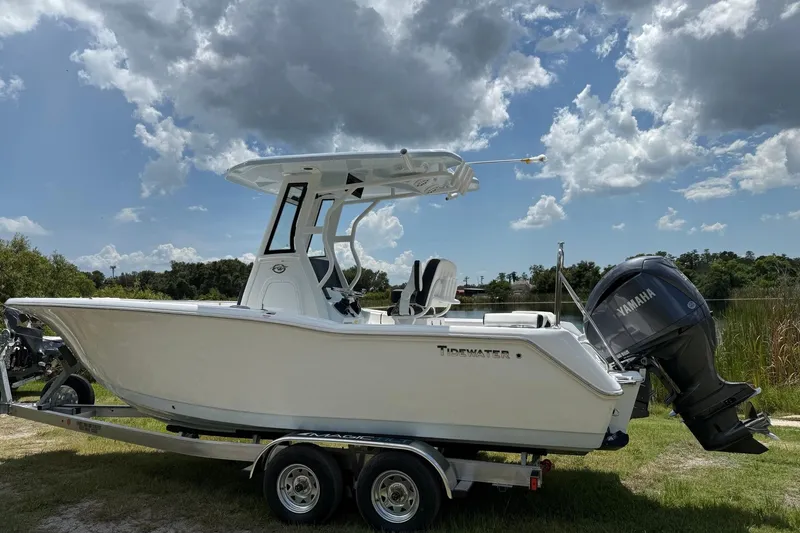 Slide: The Image of 2026 Tidewater 232 LXF boat on trailer with Yamaha engine under cloudy sky. - 3