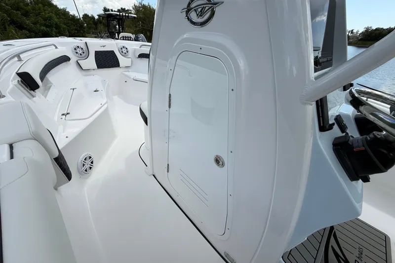 Slide: The Image of 2026 Tidewater 232 LXF boat interior with seating, speakers, and storage compartment. - 31
