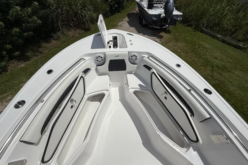 Slide: The Image of 2026 Tidewater 232 LXF boat interior with open storage compartments and sleek design. - 33