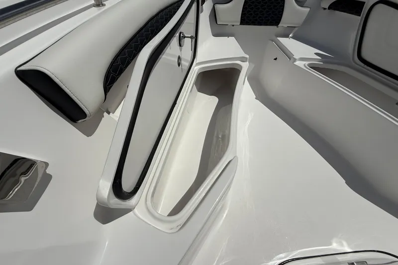 Slide: The Image of 2026 Tidewater 232 LXF boat interior with storage compartment and cushioned seating. - 34
