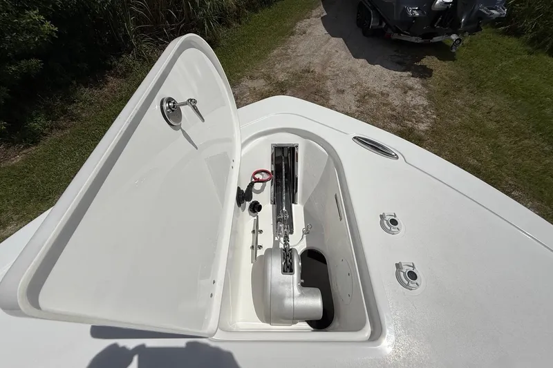 Slide: The Image of 2026 Tidewater 232 LXF boat anchor compartment, open lid, showing anchor and chain storage. - 35