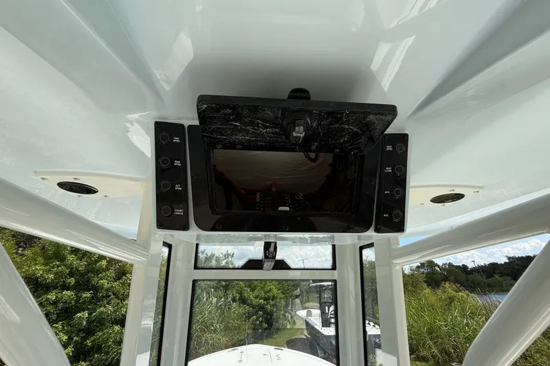Slide: The Image of 2026 Tidewater 232 LXF boat console with control panel and display screen. - 38