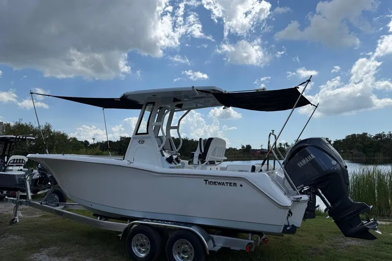 Slide: The Image of 2026 Tidewater 232 LXF boat on trailer, Yamaha engine, under blue sky. - 43