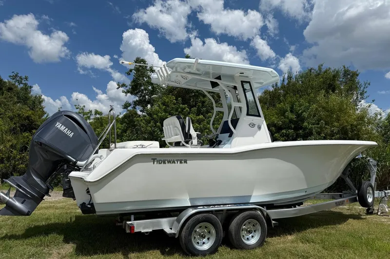 Slide: The Image of 2026 Tidewater 232 LXF boat on trailer, featuring Yamaha engine, under a partly cloudy sky. - 6