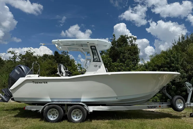 Slide: The Image of 2026 Tidewater 232 LXF boat on trailer, set against a clear blue sky. - 7