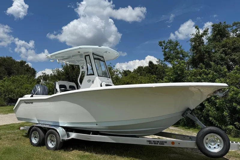 Slide: The Image of 2026 Tidewater 232 LXF boat on trailer under blue sky with clouds. - 8