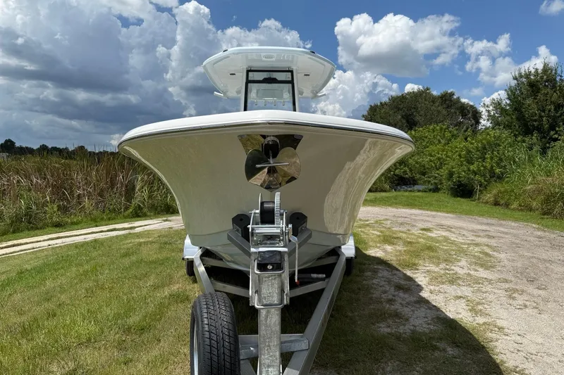 Slide: The Image of 2026 Tidewater 232 LXF boat on trailer, set against a cloudy sky and grassy landscape. - 9