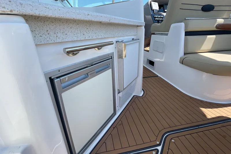 Slide: The Image of Manufacturer Provided Image: 2017 Rinker EX 370 boat interior with kitchenette and seating area. - 12