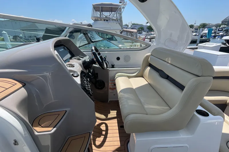 Slide: The Image of 2017 Rinker EX 370 boat dashboard with modern controls and steering wheel. - 18