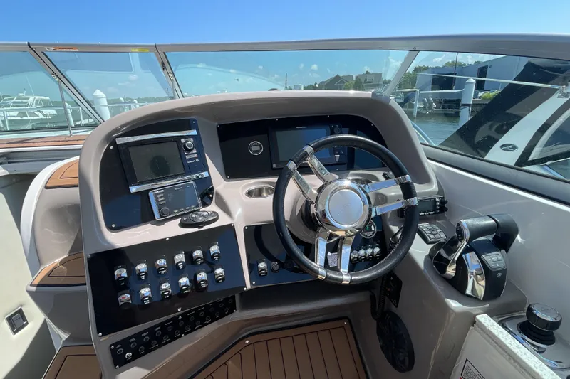 Slide: The Image of Control panel of a 2017 Rinker EX 370 boat featuring Axius system buttons. - 20