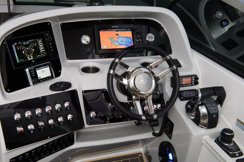 Slide: The Image of 2017 Rinker EX 370 cabin entrance with white interior and wooden table. - 21