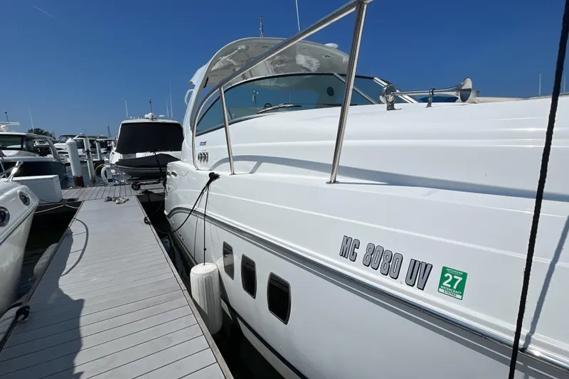 Slide: The Image of 2017 Rinker EX 370 yacht interior with wood finishes and white seating. - 3