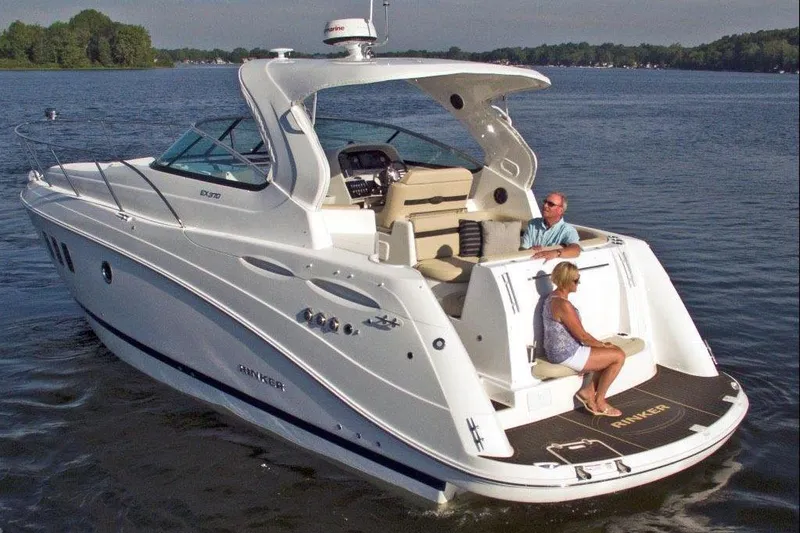 Slide: The Image of Interior of a 2017 Rinker EX 370 boat with beige seating and wooden flooring. - 4