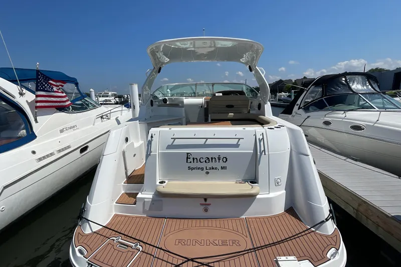 Slide: The Image of 2017 Rinker EX 370 boat docked, featuring a spacious deck and elegant design. - 6