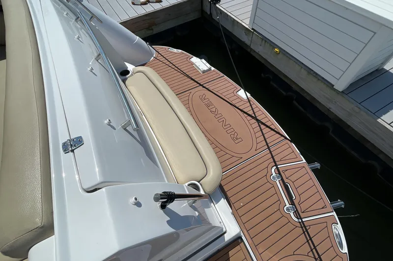 Slide: The Image of 2017 Rinker EX 370 boat docked, featuring a teak-style swim platform. - 7