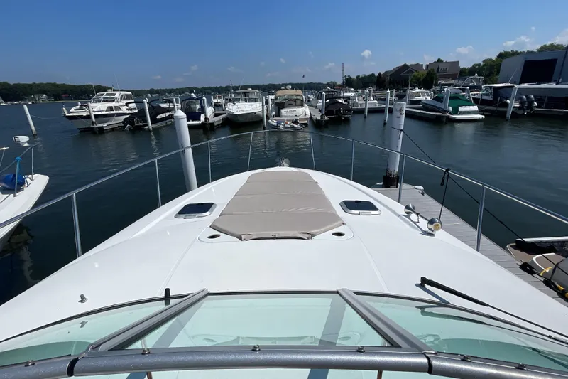 Slide: The Image of 2017 Rinker EX 370 yacht docked at a marina, surrounded by other boats. - 9