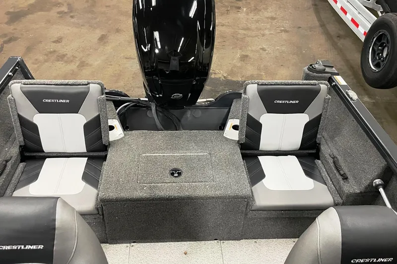 Slide: The Image of 2019 Crestliner 1650 Fish Hawk WT JS boat interior with cushioned seating and motor. - 2