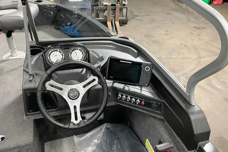 Slide: The Image of 2019 Crestliner 1650 Fish Hawk WT JS boat dashboard with steering wheel and navigation system. - 4