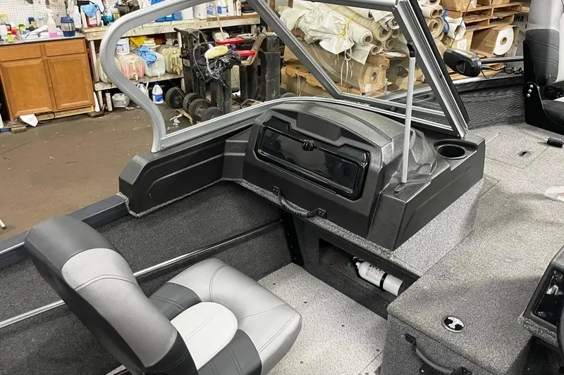 Slide: The Image of 2019 Crestliner 1650 Fish Hawk WT JS interior with seating and dashboard in workshop. - 5